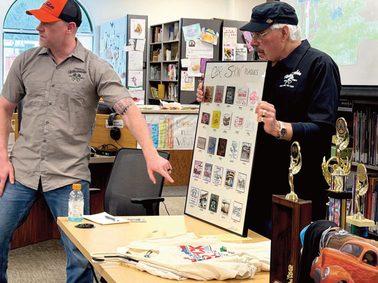 Blanchardville car show organizer Aaron Jorenby (left) and show founder/original organizer Frank Schlumpf display a framed collection of Blanchardville Cruis'n Wisconsin Car Show plaques at the Sunday, March 22 Blanchardville Historical Society's annual meeting. Photo by Gary Mckenzie.