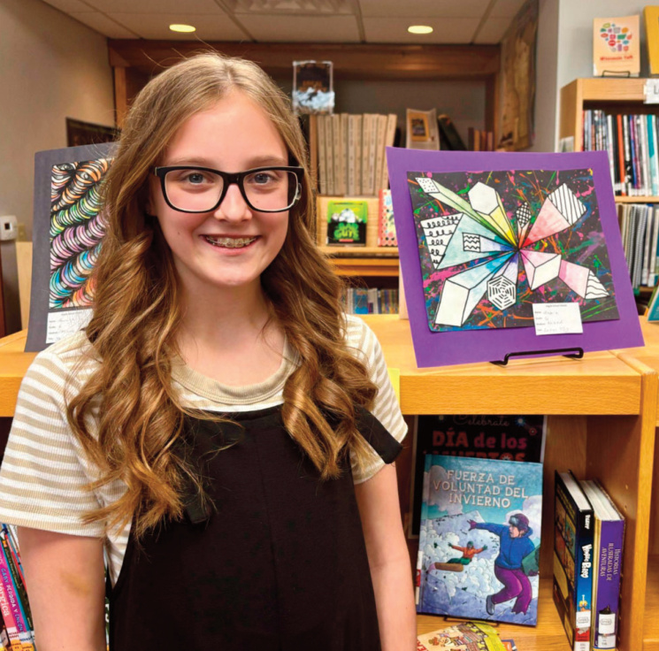 Aubrie, Grade 6, created a mixed-media piece titled Laser Tag that explores depth. For this assignment, students were challenged to combine splatter art with geometric shapes. She began by building a background using bright paint and strands of yarn to achieve a splatter-like effect. She then used a "one- point perspective technique and made a horizon line and single point" on which to center the composition. The shapes - cut from separate pieces of paper - radiate from the central point. Aubrie said she used value, blending colors from light to dark so the shapes appear to pop off the page. She also added unique designs into the shapes, adding interest and detail.