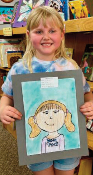 Sophia, Grade 1, made this self-portrait in an animation style. She combined a variety of materials - colored paint, Sharpie, crayon, and marker - to bring the piece to life. For the eyes, she used "shiny crayons," giving them a bright sparkle. Sophia chose a purple t-shirt for her portrait, explaining that purple - along with teal - is one of her favorite colors. She said she especially likes how the hair turned out.