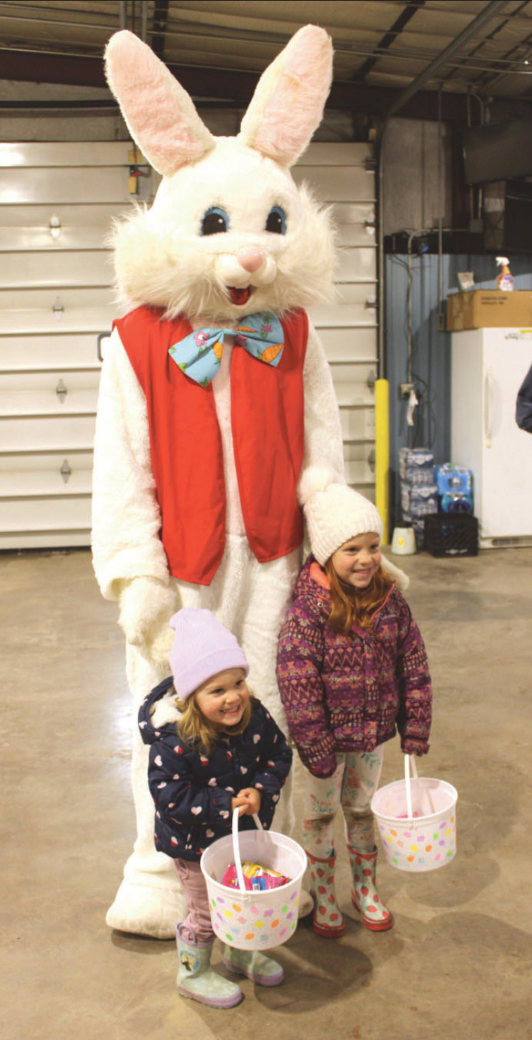Elvie and Addy Goninen of Hollandale taking pictures with the Easter Bunny.