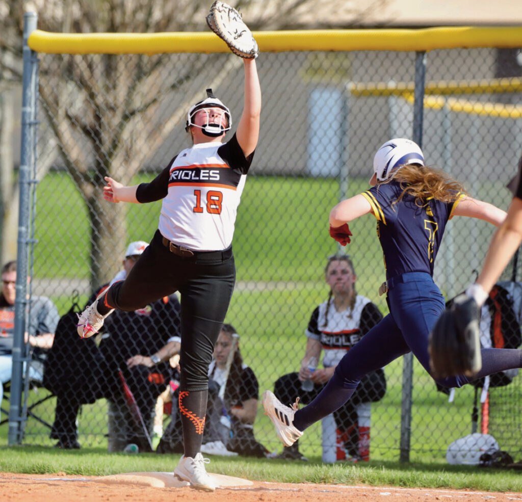 Argyle/Black Hawk's Claire Holmes snags a high throw at first base.
