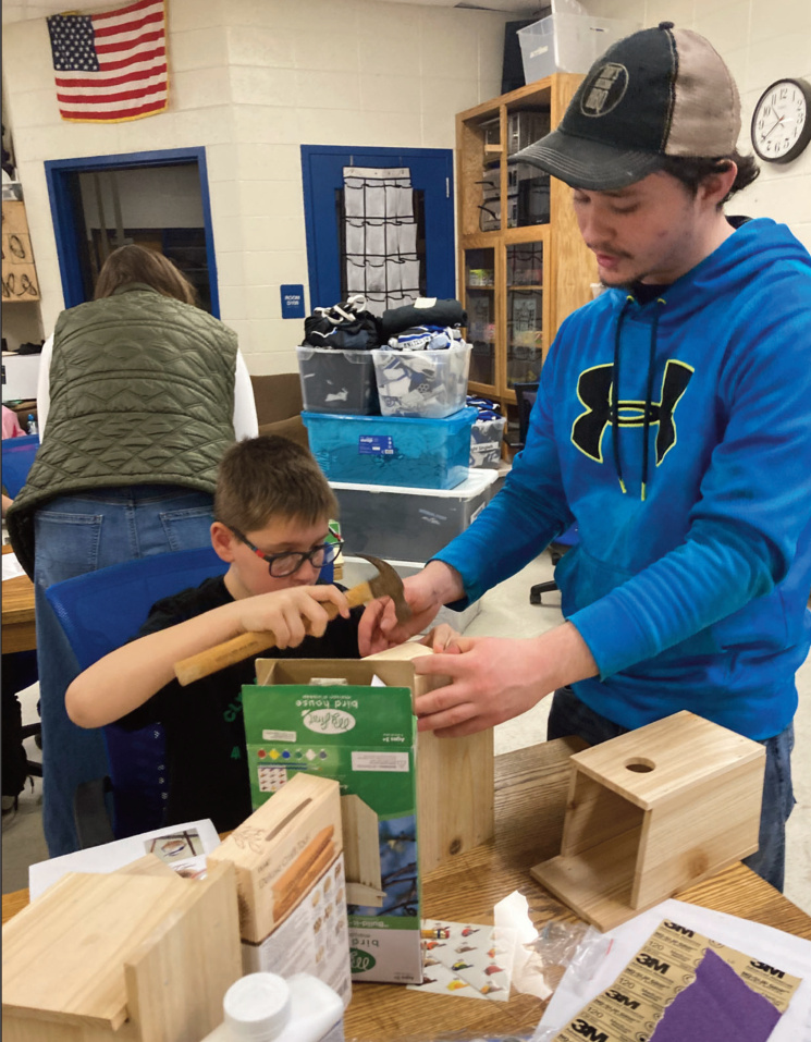 James Steele of Pleasant View 4-H Club, help younger members build their own birdhouse.