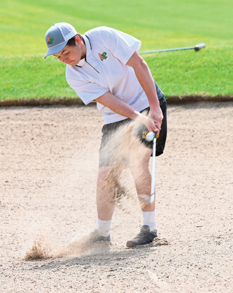 Tucker Bethke hits from the sand. Photo by Anita Schmid.