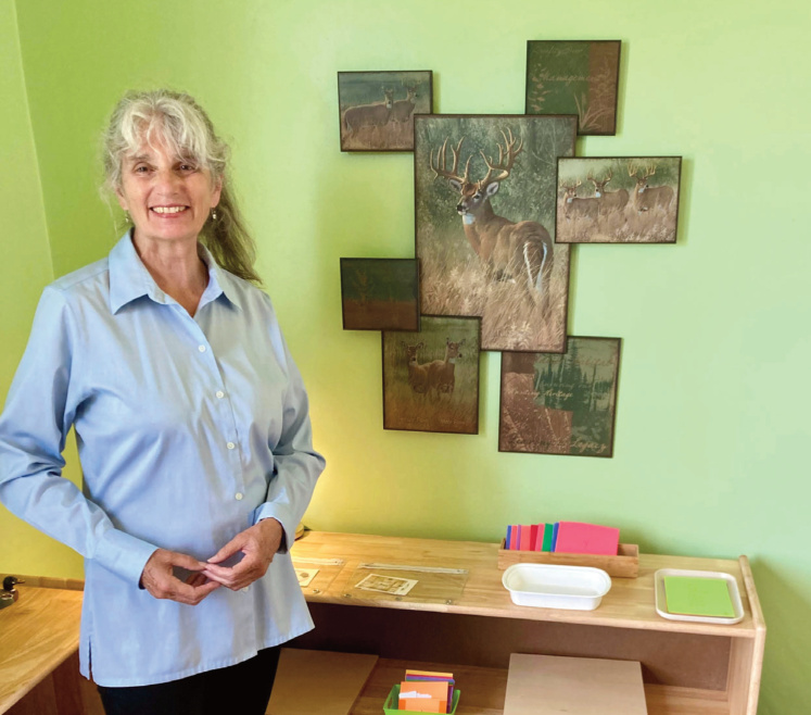 A picture of Lynn Rossing next to portraits of deer