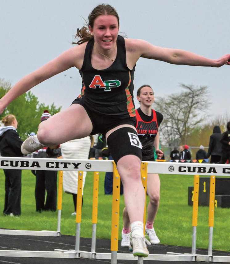Loretta Tisch clears a hurdle. Photo by Bret Peterson.