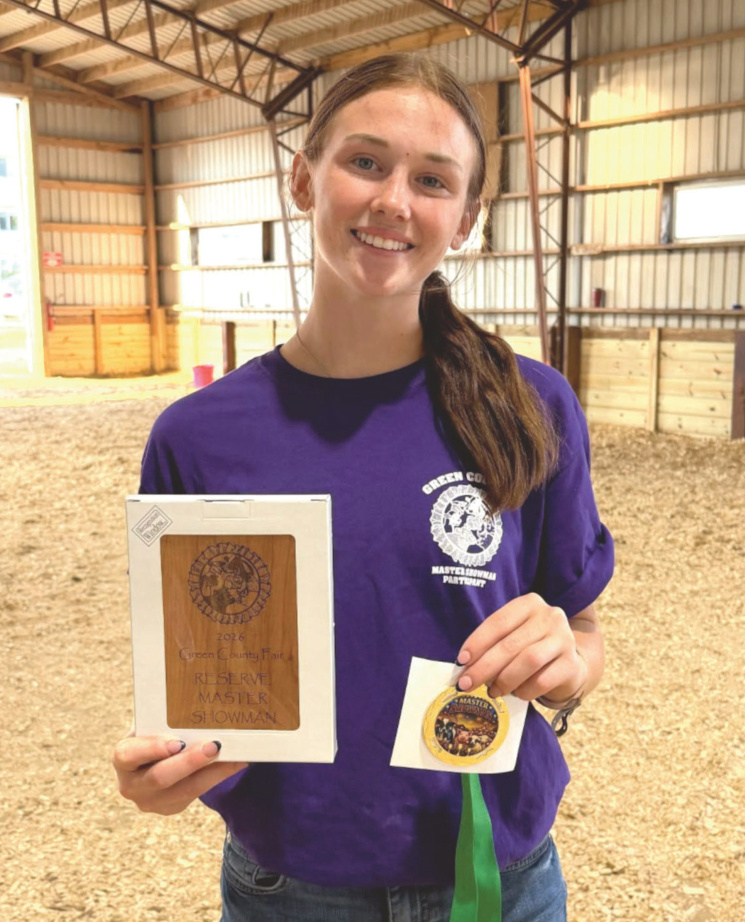 Katelynn Jorenby holding her reserve champion master showman award