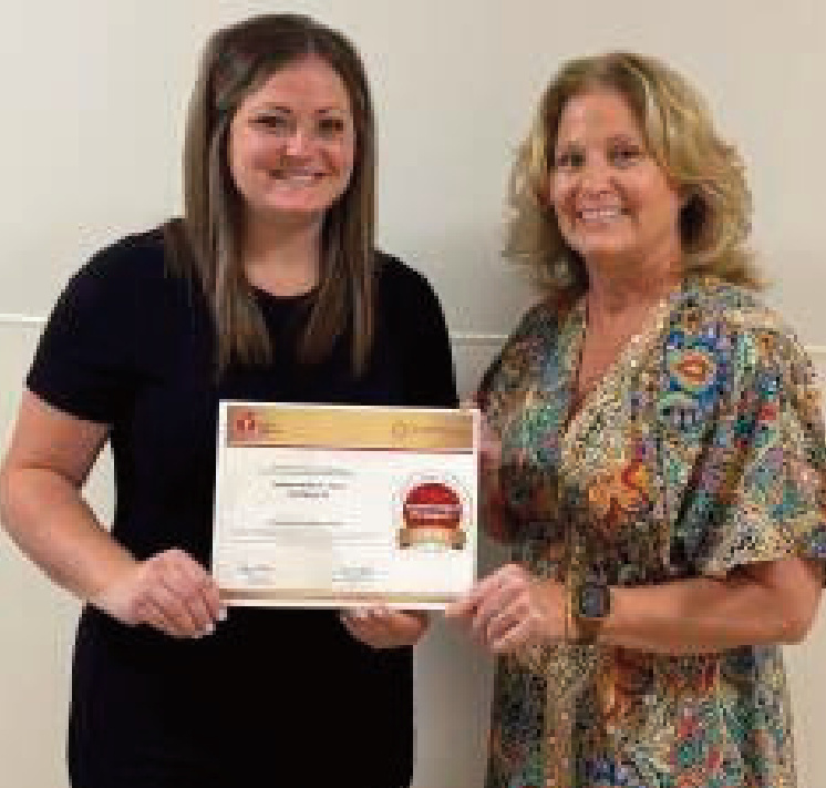 Two women receiving an award for Lafayette Hospital & Clinics