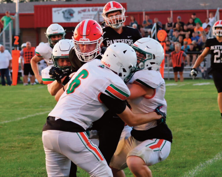 Mike Helfvogt (6) and two others bring down an I-G running back.